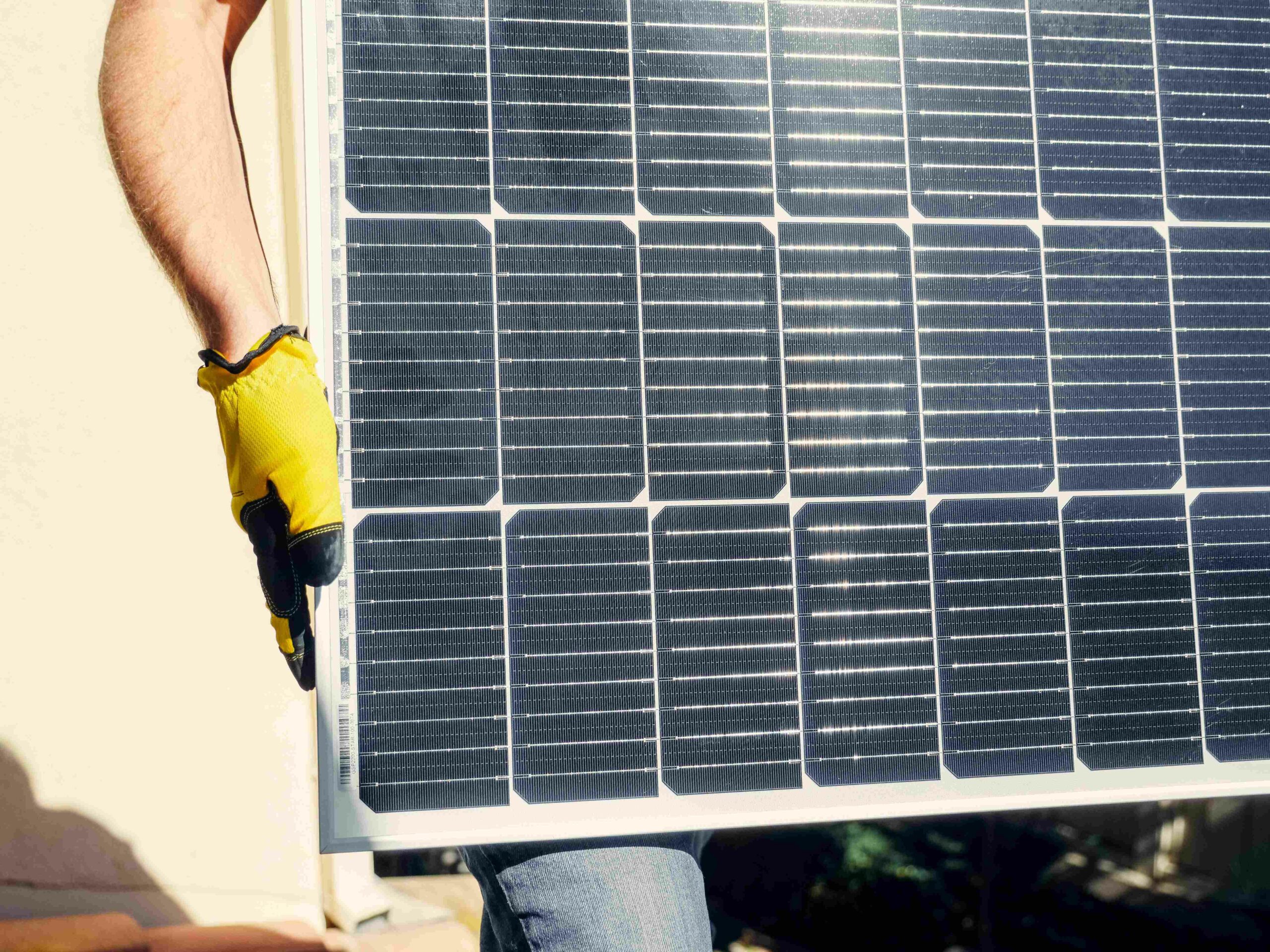 Photo by Kindel Media: https://www.pexels.com/photo/a-person-carrying-a-solar-panel-9875449/