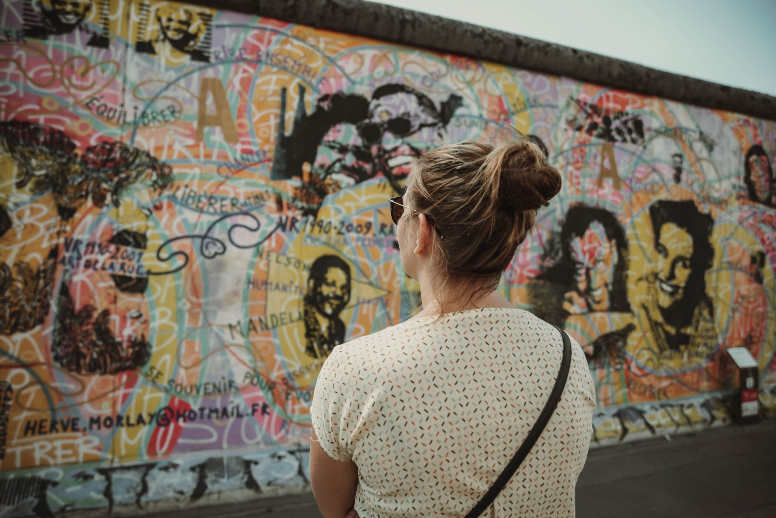 Photo by Ann Buht: https://www.pexels.com/photo/a-woman-looking-at-the-berlin-wall-12996469/